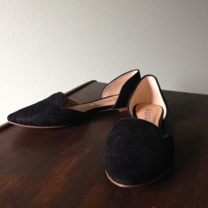 Pointy toe flat in black faux snake skin.